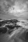 USA, New Jersey, Cape May National Seashore. Ocean and waves hitting rocks at sunrise. Art Print